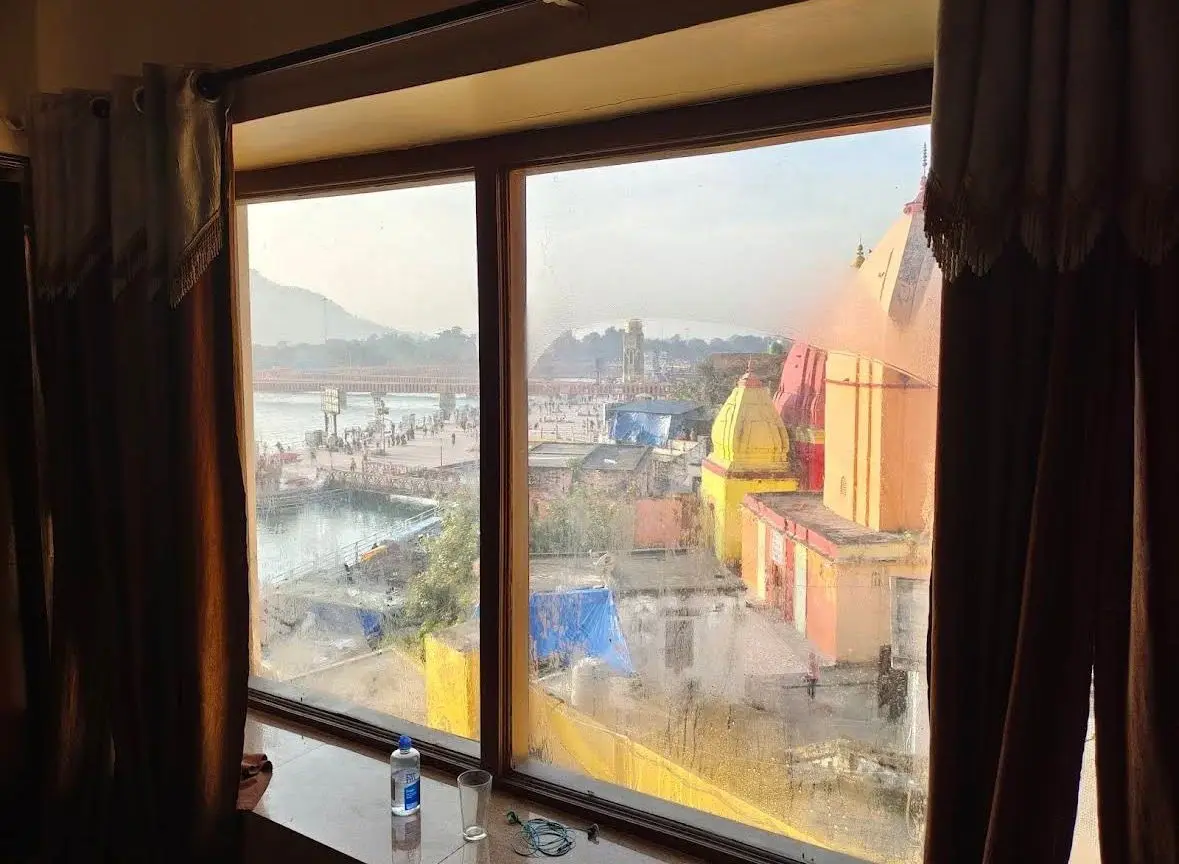Ganga river and temple view from hotel room window in Haridwar near Har Ki Pauri